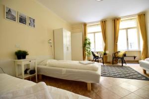 a bedroom with two beds and a living room at EcoStay Apartment by the Basilica in Budapest