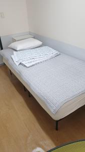 a mattress sitting on a bed in a room at dakwan stay in Seoul