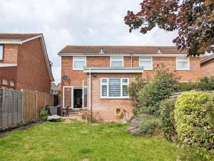 a brick house with a yard in front of it at Brook House - Emsworth in Emsworth