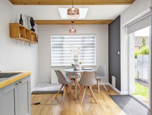 a kitchen and dining room with a table and chairs at Brook House - Emsworth in Emsworth