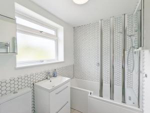a white bathroom with a shower and a sink at Brook House - Emsworth in Emsworth +14 photos