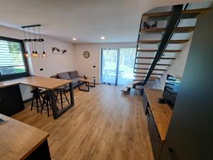 een woonkamer met een eettafel en een trap bij Riverside Apartma 2, Kranjska Gora in Kranjska Gora