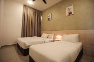 a hotel room with two beds and a window at C&Y Lee CIean@Cozy House in Melaka +45 photos