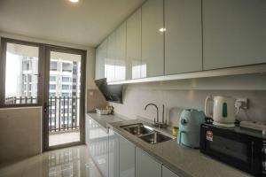 a kitchen with a sink and a microwave at C&Y Lee CIean@Cozy House in Melaka