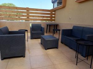 a patio with blue chairs and tables at Mool Gilboa - מול גלבוע in Bet Sheʼan