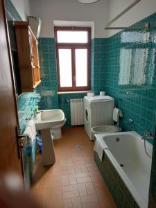 a bathroom with a tub and a toilet and a sink at BELLAVISTA - Appartamenti sul Lago di Scanno in Scanno +65 photos