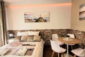 a bedroom with a bed and a table and chairs at Modern Apartment SANDY BEACH down town, aquapark, free parking in Kraków