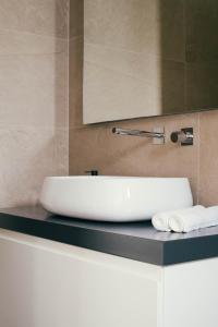a white sink on a counter in a bathroom at Orange Boutique Residence - Casa Diogo in Quarteira +14 photos