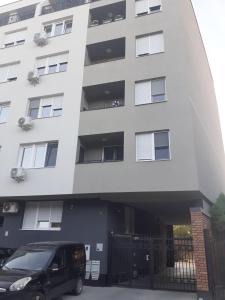 a black van parked in front of a building at Apartman Gabi in Subotica