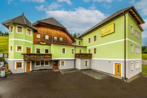 a large building with a parking lot in front of it at Waldschlössl Gasthof in Sankt Lorenzen ob Murau