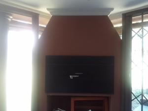 a living room with a fireplace with a flat screen tv at Room2rent Centurion in Pretoria