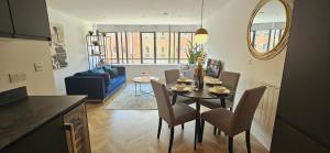 a kitchen and living room with a table and chairs at Lamberts House - 2 Bed, 2 Bathroom in Leeds
