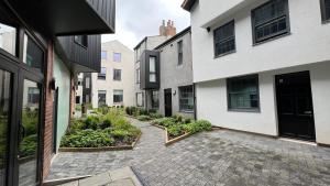 a courtyard with some plants and some buildings at Lamberts House - 2 Bed, 2 Bathroom in Leeds