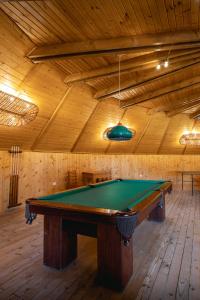 a pool table in a room with a wooden ceiling at Dolphin Camping in Sfântu Gheorghe