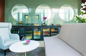 a room with two chairs and a table and mirrors at Hilton Warsaw City Hotel in Warsaw