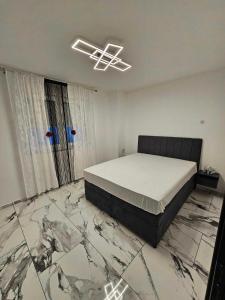 a bedroom with a bed and a marble floor at Aleksandro&Michell in Rijeka