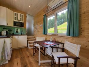 a kitchen with a table and chairs in a room at Tinyhaus Villa to go in Reichenau +27 photos
