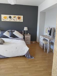 a bedroom with a bed and a table and a desk at A luxiourious Room in the best terraced Penthouse in Denia Building 3 in Denia