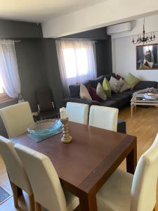 a dining room table with white chairs and a couch at A luxiourious Room in the best terraced Penthouse in Denia Building 3 in Denia