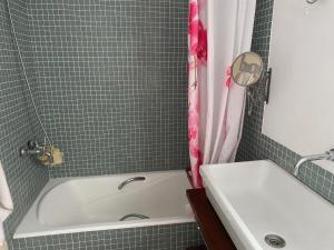 a bathroom with a white tub and a sink at A luxiourious Room in the best terraced Penthouse in Denia Building 3 in Denia