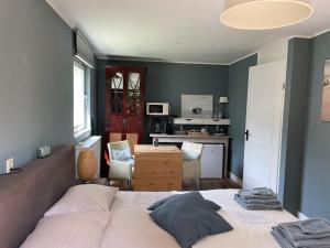 a bedroom with a large bed and a desk at Dunes & Sea at Kijkduin in The Hague