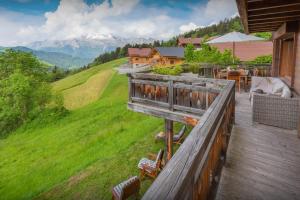 a balcony of a house with a view of a mountain at Chalet Isatys - OVO Network in Manigod