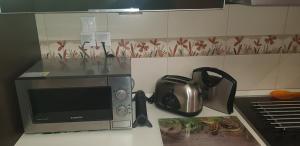 a kitchen with a microwave and a tea kettle at villa strati in Nafplio