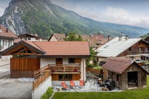 a house with a mountain in the background at Chalet 65bis - OVO Network in Thônes