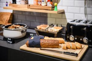 a counter with a cutting board with bread on it at Moxy Paris Bastille in Paris