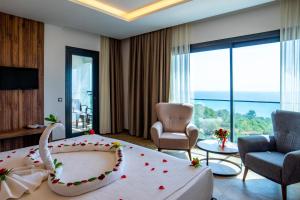 a hotel room with a large bed with flowers on it at CİTY POİNT BEACH&SPA HOTEL in Didim