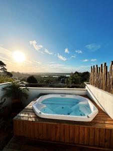 a jacuzzi tub sitting on top of a deck at Nomads Flats in Itacaré