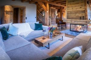 a living room with couches and a fireplace at Chalet Beau Caillou - OVO Network in Saint-Gervais-les-Bains