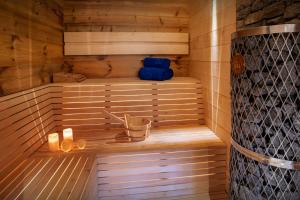 a sauna with two blue towels and candles in it at Chalet Beau Caillou - OVO Network in Saint-Gervais-les-Bains