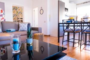 a living room with a couch and a table at ViVaTenerife - Cosy and elegant flat in Los Abrigos in Los Abrigos