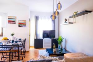 a living room with a table and a dining room at ViVaTenerife - Cosy and elegant flat in Los Abrigos in Los Abrigos