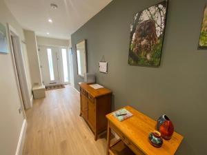 a living room with a wooden table and a wooden floor at Rosegarth Bed and Breakfast in Marton