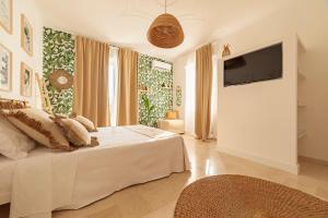a bedroom with a bed and a flat screen tv at LA CASITA in Alassio