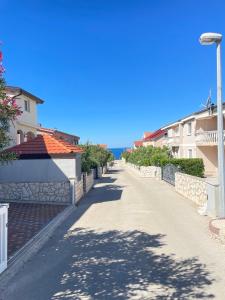 an empty street with buildings and a street light at Apartment Vito in Mandre +28 photos