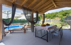a patio with a table and chairs and a pool at Villa Lucia in Vukići