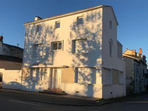 a white building with a shadow on the side of it at maison blanche in Eymet