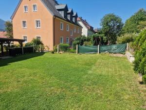 a yard with a fence and a house at Apartment Emma in Liezen