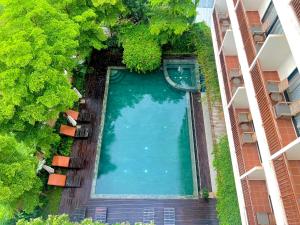 een uitzicht over een zwembad tussen twee gebouwen bij DACO Hotel in Siem Reap