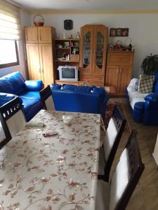a living room with a blue couch and a table at DRAGICA Manastirska 10 in Ljubovija