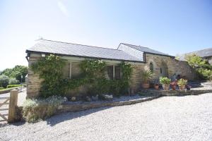 a brick house with plants on the side of it at Little Forge in Saint Mawgan