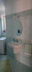a bathroom with a sink and a mirror at Appartamento stile rustico in collina 