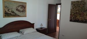 1 dormitorio con 1 cama y una pintura en la pared en Appartamento stile rustico in collina 