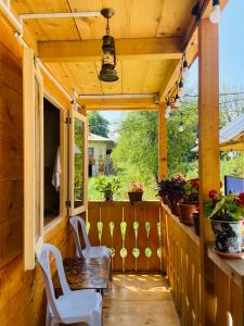 a screened in porch with a table and chairs at House in The Mountains in Khulo +10 photos