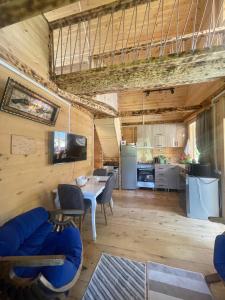 a living room with a table and a kitchen at House in The Mountains in Khulo