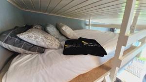 a bunk bed with pillows on top of it at Tiny House, Kesk Loft in Tartu