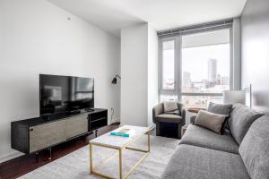 a living room with a couch and a flat screen tv at SoMa 2BR w Gym Roofdeck nr Pinterest SFO-332 in San Francisco